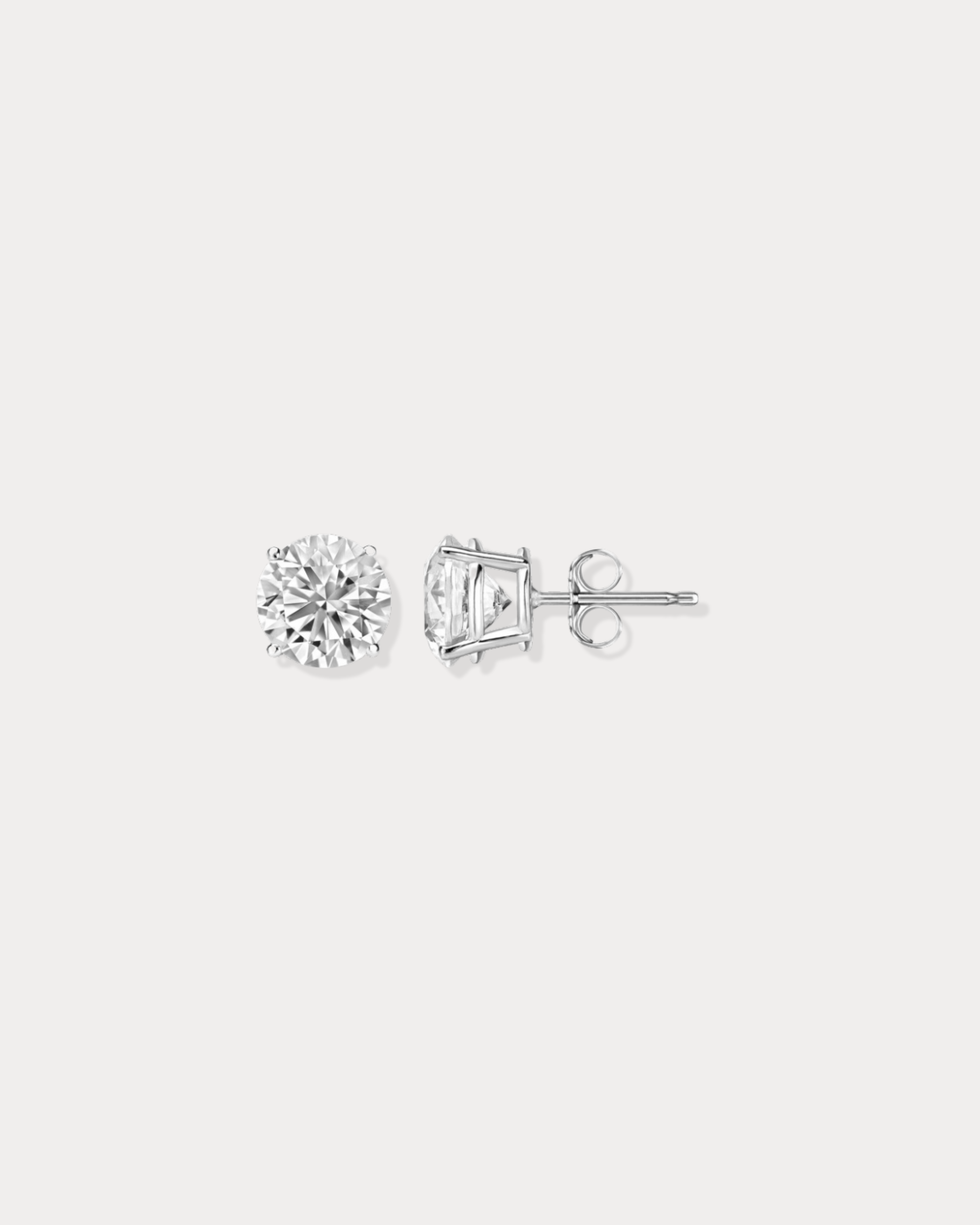 Diamond stud earrings on a light gray background