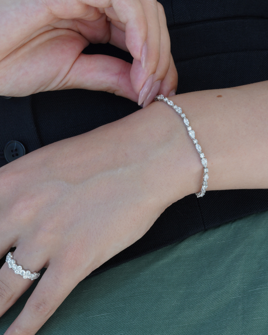 Tri-shape lab diamond tennis bracelet with pear, marquis, and round shapes on a model, showcasing timeless elegance and sustainable luxury."