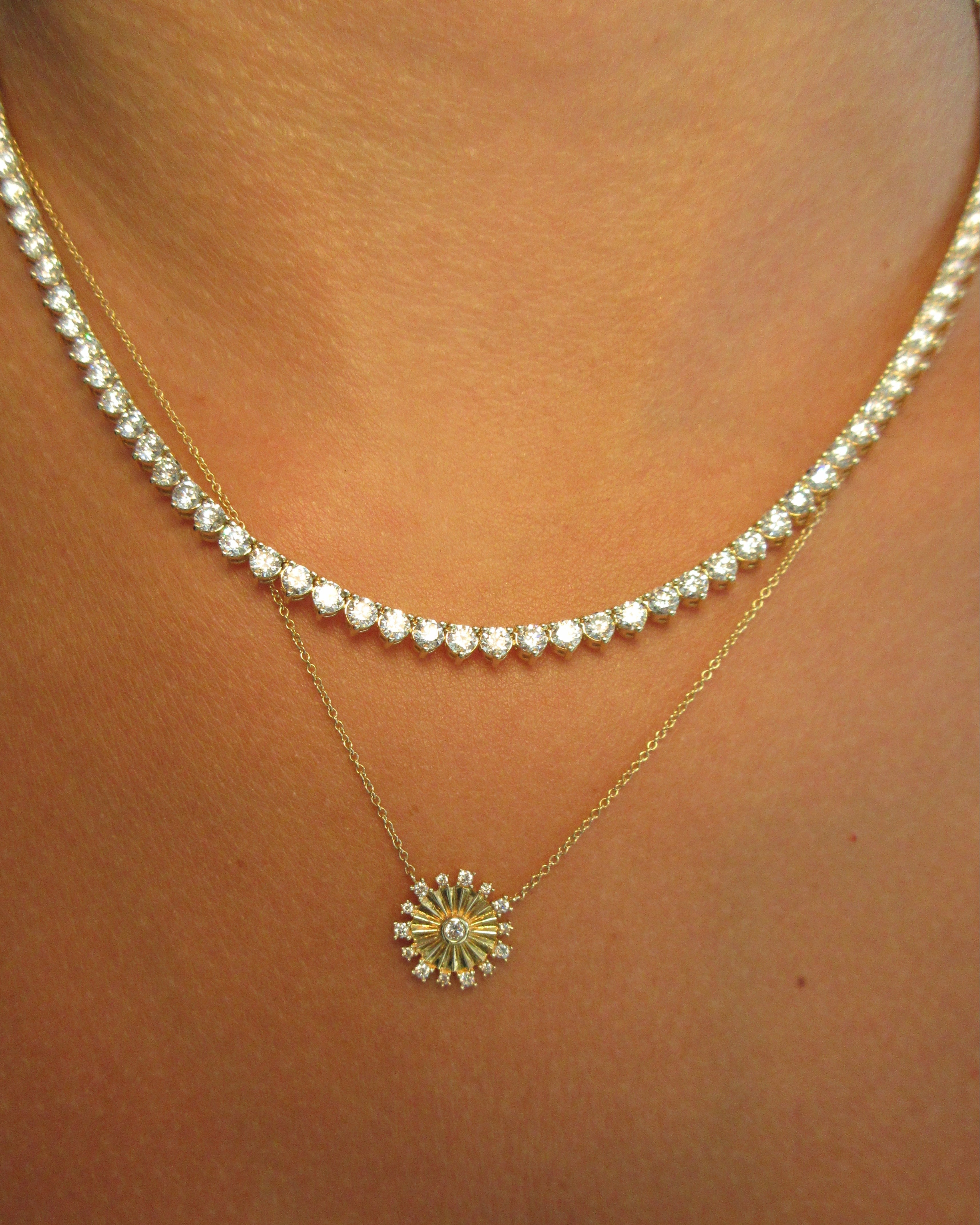 Close-up of a pearl necklace and gold anklet on a person's ankle.